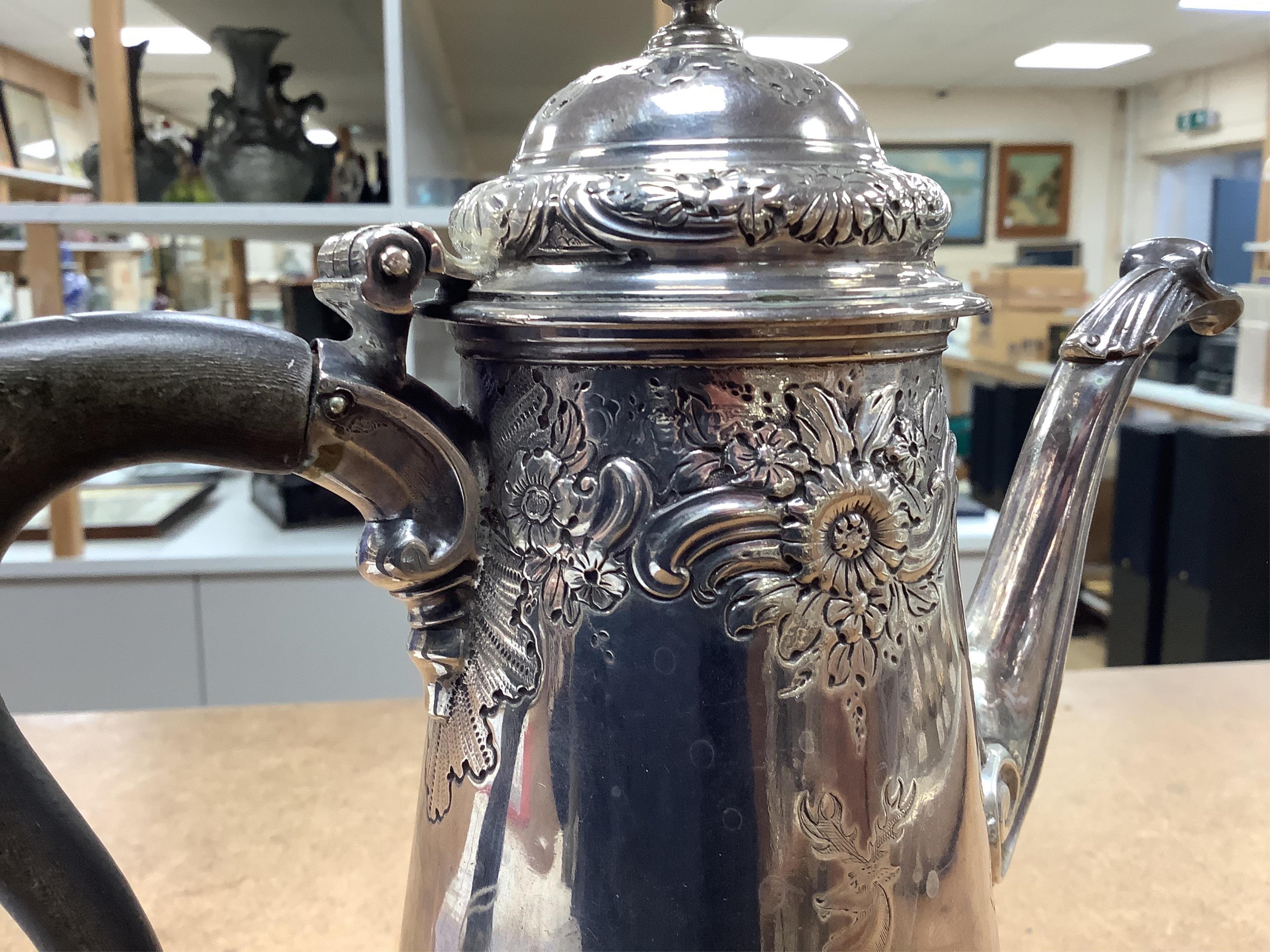 A George II silver coffee pot, with later embossed decoration, by Gurney & Cook, London, 1749m height 23.3cm, gross weight 22.2oz.